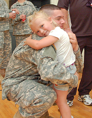 Pvt. Scott Mix, a student, hugs his niece at t...