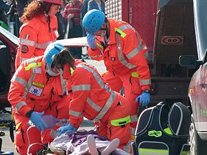 English: Italian EMTs performing CPR on an moc...