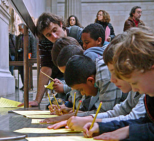 English: A teacher and young pupils at The Bri...