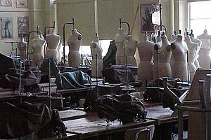 A classroom filled with sewing machines and ma... A classroom filled with sewing machines and ma...