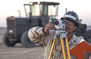US Navy Surveyor at work with a leveling instr... US Navy Surveyor at work with a leveling instr...